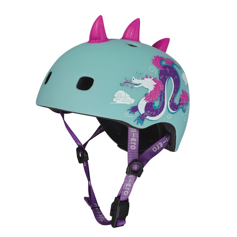 Turquoise børnehjelm med pink pigge og drage-design i pink og lilla på siden.